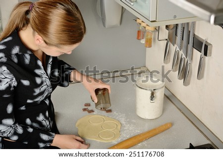 Woman prepare dough on the table in the kitchen