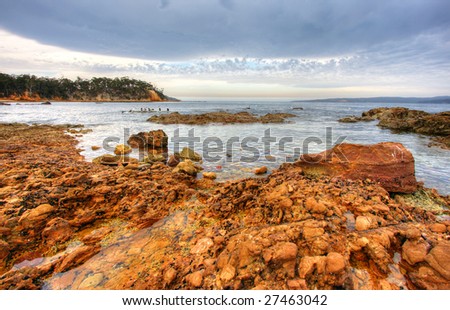 Rock pools against a cloudy sky in Eden, NSW