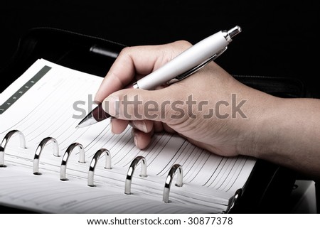 Women witting an appointment in a personal planner