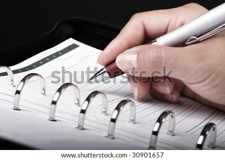 Women witting an appointment in a personal planner