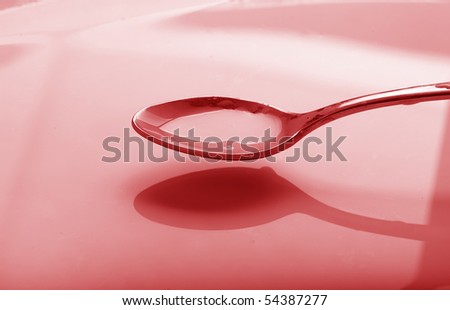 a spoon full of syrup over a bowl