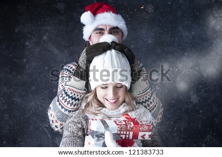Happy funny  couple   covering  snow background.fooling around. Snowy card.