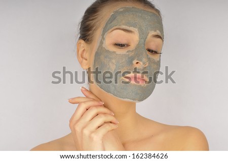 Cosmetics mask of clay on the beautiful young female face
