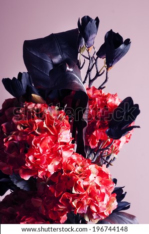 bouquet of red hydrangea and dark blue magnolia in a vase