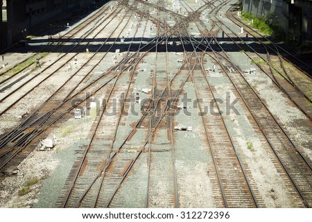 High angle view looking down on rusty railroad tracks, filtered high contrast.
