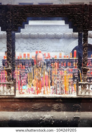 CHONGQING - MARCH 18: Incense sticks burning in a Buddhist temple on March 18, 2012 in Chongqing. In Chinese Buddhist temples, burning incense is reputed to be a method of purifying the surroundings.