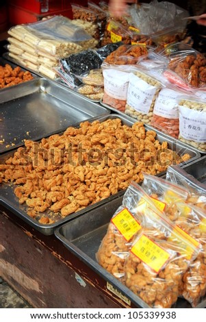 CHONGQING - MARCH 19: A stall selling traditional sweets in a street on March 19, 2012 in Chongqing. According to the Food and Agriculture Organization, 2.5 billion people eat street food every day.