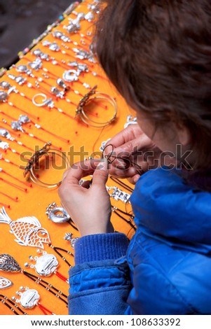 FENGHUANG - MARCH 23: A jewelry vendor on March 23, 2012 in Fenghuang, China. Jewelry making in China started 5,000 years ago but it became widespread with the spread of Buddhism 2,000 years ago.