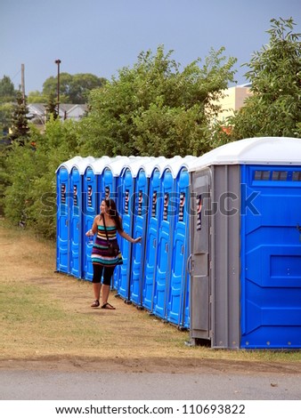 TORONTO - JULY 22: A line of portable toilets at an outdoor event on July 22, 2012 in Toronto. The modern plastic portable toilet has been manufactured since the 1960s.