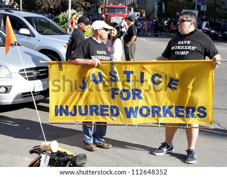 TORONTO - SEPTEMBER 3: A banner supporting justice for injured workers on September 3, 2012 in Toronto. The 2012, was the 141st edition of the annual Toronto Labor Day Parade.