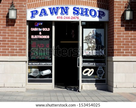 TORONTO - SEPTEMBER 6: A pawn shop on September 6, 2013 in Toronto. Pawnbroking is a form of business that exists since the Ancient Greek and Roman Empires.