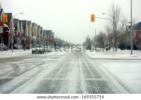 TORONTO - DECEMBER 14: Icy roads on December 14, 2013 in Toronto, Canada. Winter driving in Southern Ontario might be risky due to snowy and icy roads.