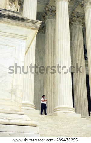 WASHINGTON DC, U.S.A. - APRIL  14, 2015: A security guard outside the Supreme Court building in Washington DC.