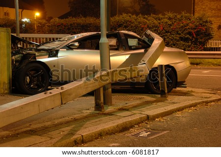 Car crashed under barrier at night, Editorial shot