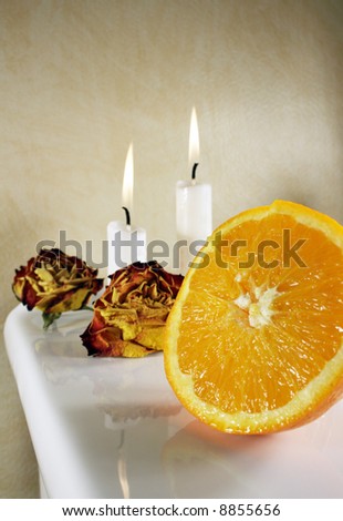 Fresh orange with roses and candlelights for some romance