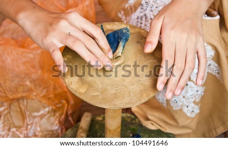during molding earthen bowl for making thai candle