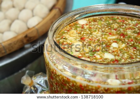 thai spicy seafood sauce in big jar before separate packing for retail sale in local market make of fish sauce, garlic, chilli, sugar