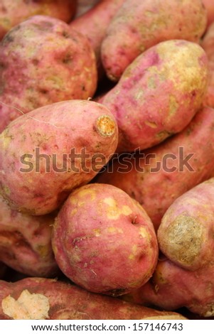 pile of raw sweet potato for retail sale in local market
