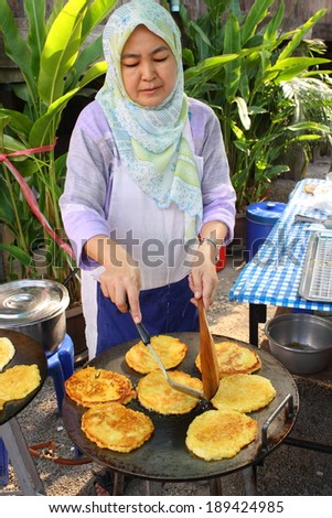 CHIANG MAI, THAILAND-APR25 : Native muslim female merchant preparing thai homemade dessert to sale  in a local halal food market in chiang mai, On Apr 25, 2014, in Chiang Mai, Thailand.