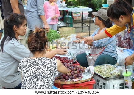 CHIANG MAI, THAILAND-APR25 : Native female merchant and her customer while doing work at a local market in chiang mai, On Apr 25, 2014, in Chiang Mai, Thailand.