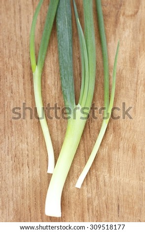 Spring onion on wooden chopping block