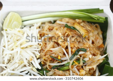 stir-fried rice noodles in biodegradable food box. pad-thai. vegetarian thai food. noodle dish.