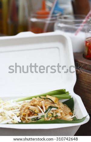 stir-fried rice noodles in biodegradable food box. pad-thai. vegetarian thai food. noodle dish.