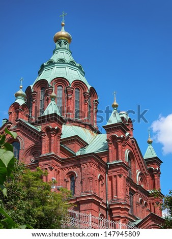 Uspenski Cathedral, largest orthodox church in Western Europe, in Helsinki Finland, against blue sky with copy space.