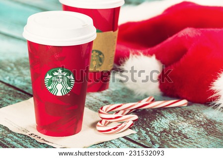 DALLAS, TX - NOVEMBER 18, 2014: A cup of Starbucks popular holiday beverage, peppermint mocha, displayed with candy canes on wooden table.