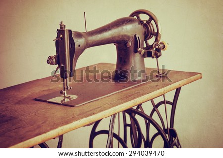Old sewing machine on textured vintage background