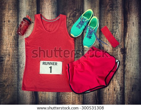 Running gear laid out ready for a race day, rustic wooden background