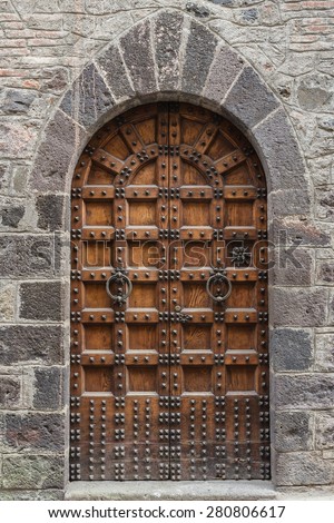 old wooden door of a broken brick wall