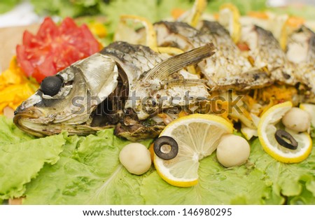 Close up view of prepared fish with vegetables