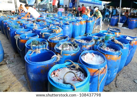 RANONG, THAILAND - JULY 16: The merchants arrange the bucket which plenty of fish and trade it in the biggest fish market one in southern of Thailand at Sapaanpla on July 16,2012 in Ranong, Thailand