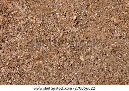 Red clay surface. Small stones. Abstraction. Background.