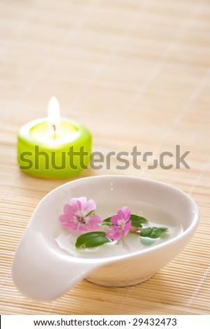 aromatherapy with little bowl flowers candle and lot of copy space