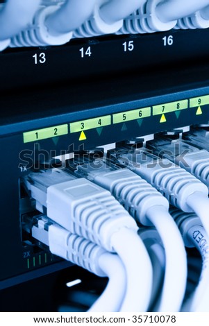 computer network cables connected to a switch and patch-panel