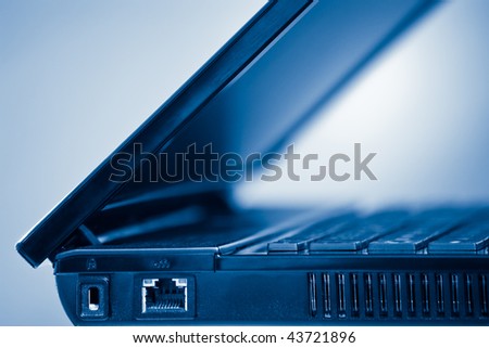 laptop computer detail with shallow depth of field blue toned