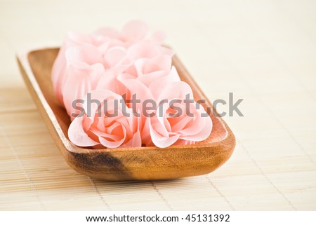 rose flowers made from soap in wood tray with shallow depth of field
