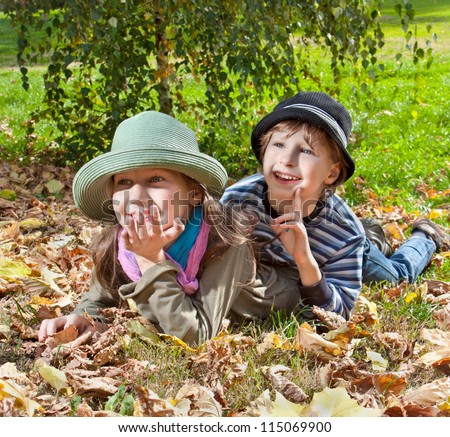 Portrait of happy girl and boy  enjoying in golden autumn fall season