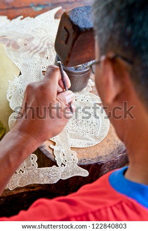 JAVA, INDONESIA - JANUARY 4: Javanese Wayang kulit worker made famous shadow puppet  on January 4 2012.in Java, Indonesia. That famous puppet are made on traditional way from buffalo leather.