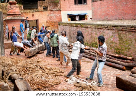 KATHMANDU,NEPAL-MAY 20: Traditional way transport of heavy things with rope and log on May 20, 2013,Kathmandu,Nepal.On United Nations list Nepal as one of the Least developed country in the world.