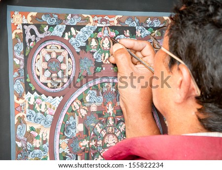 KATHMANDU, NEPAL - MAY 20: Nepalese artist drawing traditional painting on May 20, 2013 in Kathmandu , Nepal. On United Nations list Nepal as one of the Least developed country in the world.