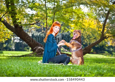 Elegant woman has fun with her big dog in the park in Novi Sad, Serbia.