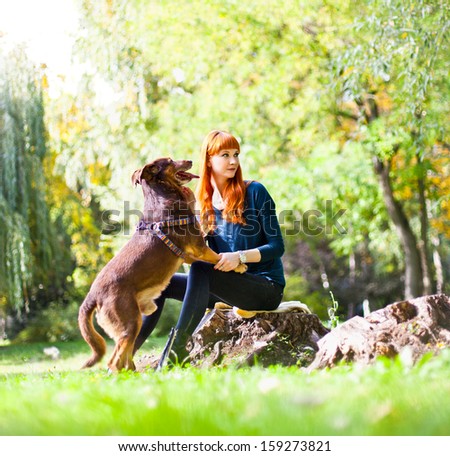 Elegant woman has fun with her big dog in the park in Novi Sad, Serbia.