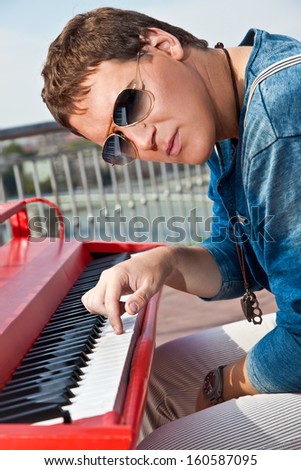 Young pianist play on his piano with bright emotions, Novi Sad, Serbia.