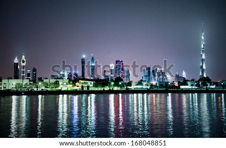 Panoramic cityscape of  Dubai  at night from seaside, United Arab Emirates.