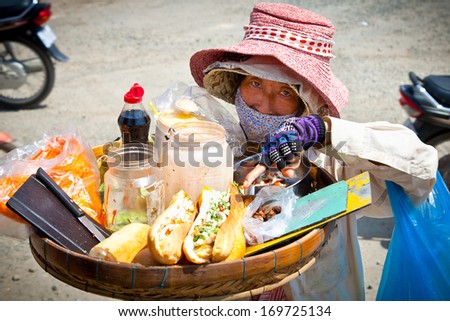 NEAK LEUNG, CAMBODIA - NOV 19, 2013: Street food vendor in the street in Neak Leung on Noveber 17, 2013, Cambodia. Estimate 34.1%  (2011 est.) of Cambodia\'s population is below the poverty line.