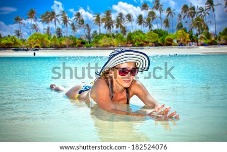 Young fashion woman relax on the beautiful tropical beach in Africa.