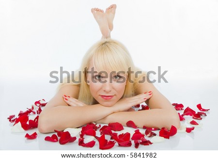 Luxury woman lying on rose petal field